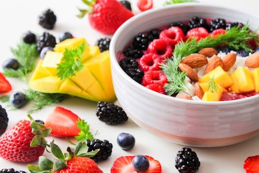 pexels photo 1105166 1105166 A vibrant bowl filled with fresh berries, mango, almonds, and herbs, perfect for a healthy snack or breakfast.