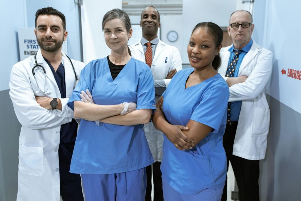 pexels photo 6129507 6129507 A diverse team of doctors and nurses smiling confidently in a hospital setting.
